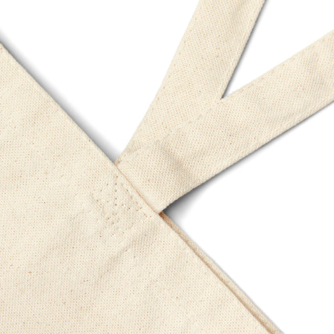 Close-up of natural cotton canvas tote bag stitching and durable 20'' handles. High-quality material for long-lasting use.